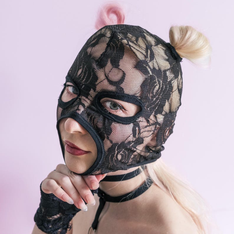 A handmade black mask with holes for letting hair through.76