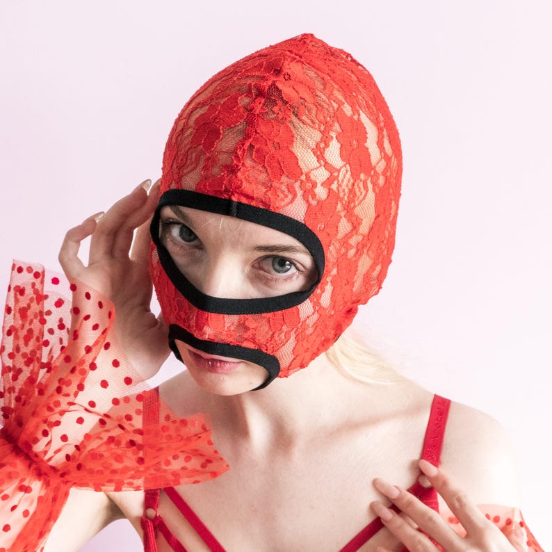 A handmade red mask with an exposed mouth and eyes.73