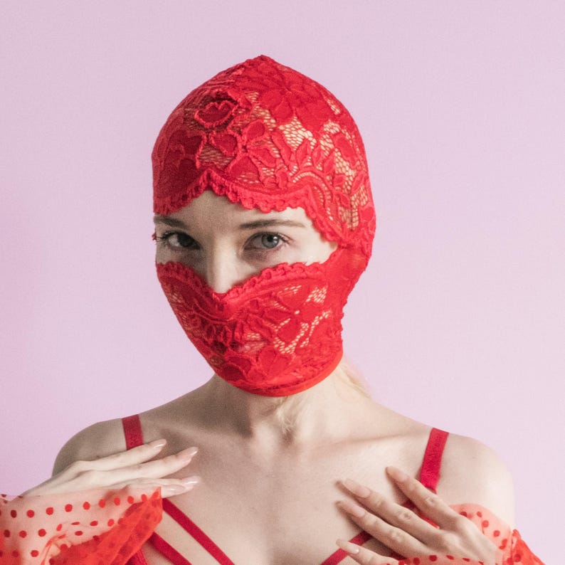 A handmade red mask, only revealing the eyes.75