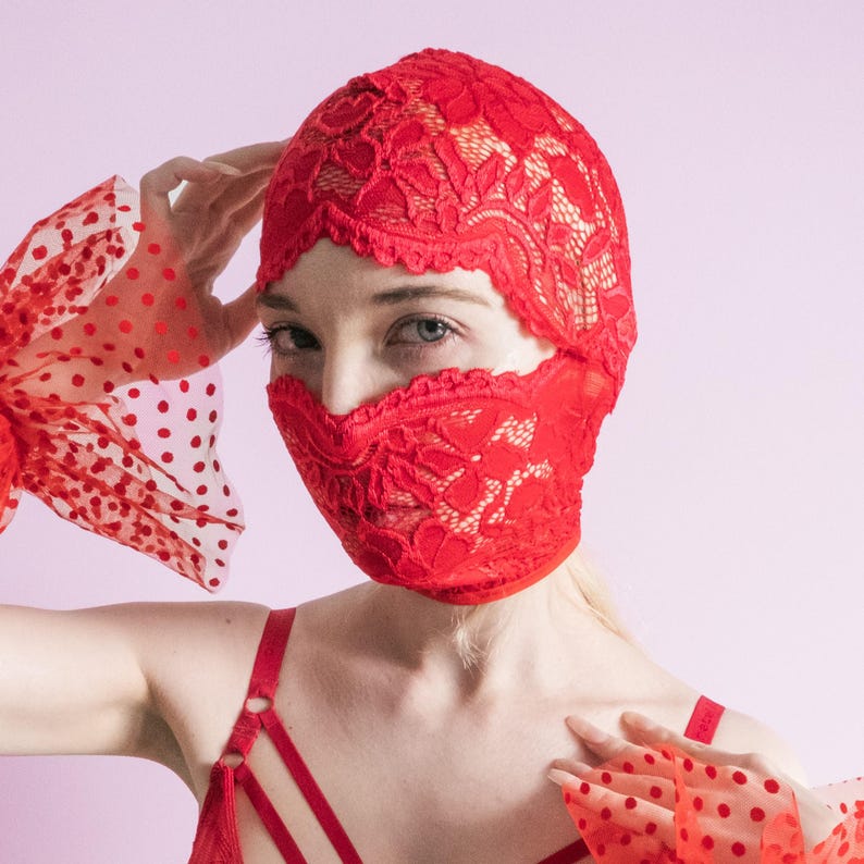 A handmade red mask, only revealing the eyes.75