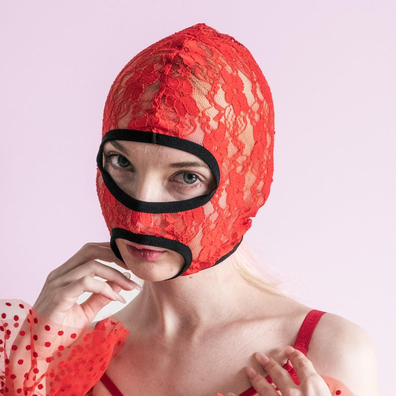 A handmade red mask with an exposed mouth and eyes.73