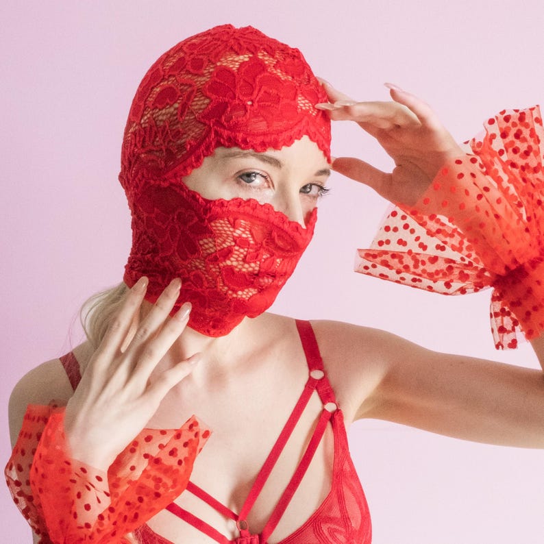 A handmade red mask, only revealing the eyes.75