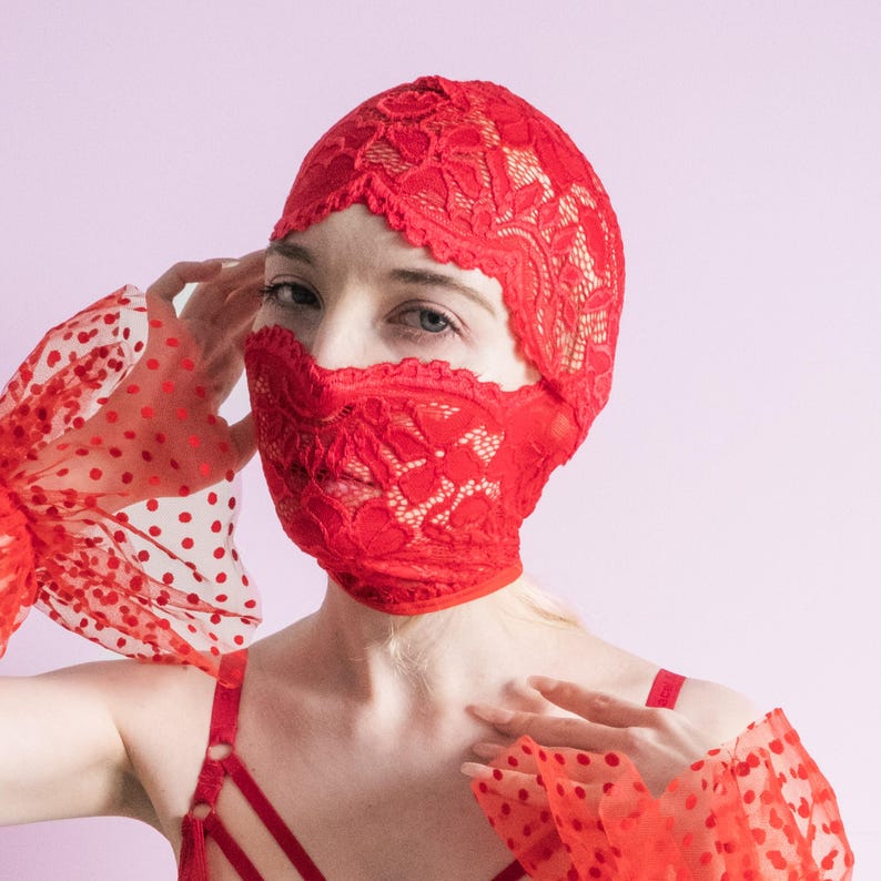 A handmade red mask, only revealing the eyes.75